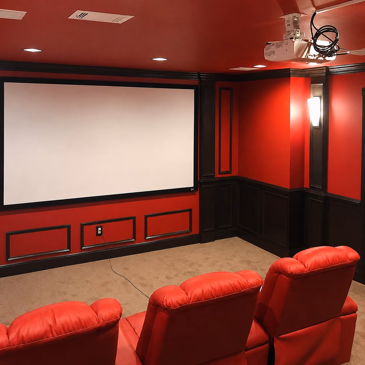 Home theater with red walls, red leather seats, projector, and a large blank screen.
