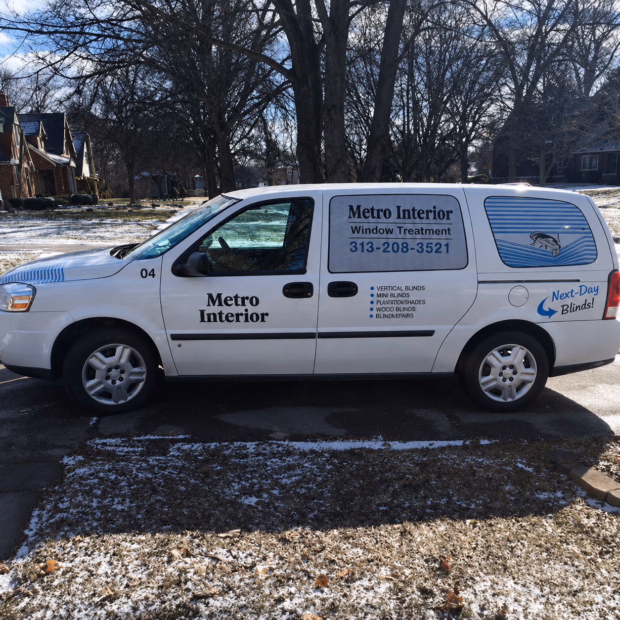 White Metro Interior company van with window treatment ads and phone number 313-208-3521 on side.