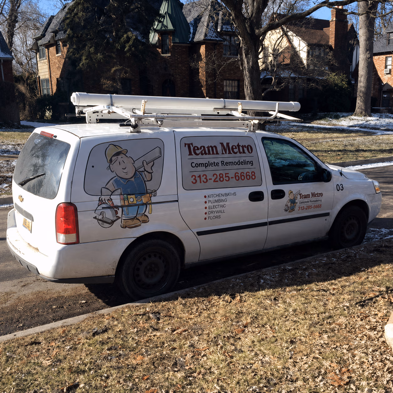 White Team Metro remodeling van parked, with ladder on top and services listed on side.